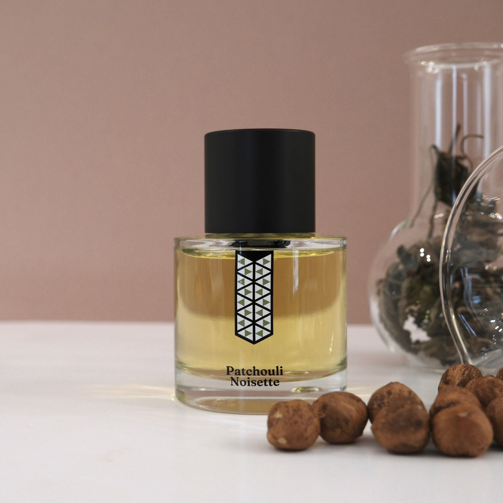 Picture displaying the exquisite 'Hazelnut Patchouli' perfume bottle by Les Indemodables, the embodiment of contemporary fragrance design.